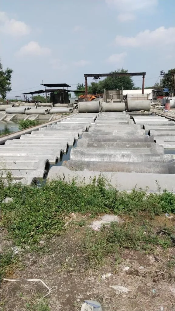 Rows of RCC septic tanks and chamber covers laid out across the Gurukrupa Enterprises manufacturing yard
